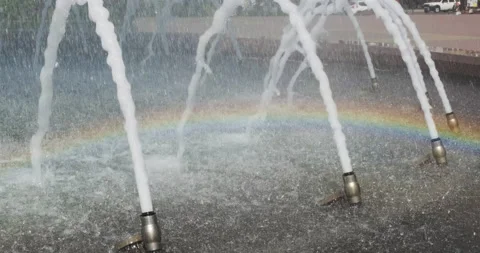 Small cute little Rainbow in front urban fountain the city with streams of water Stock-Footage 140380883