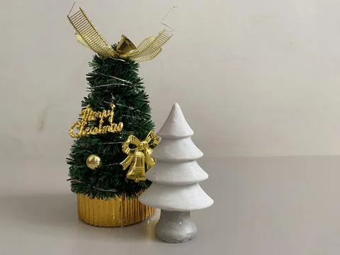 Small cute white ceramic and green Christmas tree on the table Stock Photos