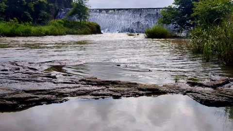 Small Dam Overflow with Water Ripples in River Stock Footage 327722078