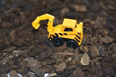 Small decorative excavator on ground. Stock Photos