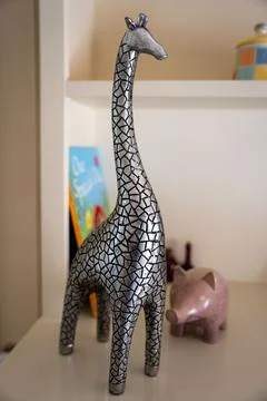 Small decorative metallic giraffe figurine on a table. Stock Photos
