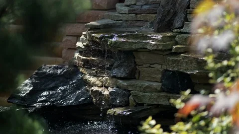 A small decorative waterfall in the Park or in the garden. Landscape design Stock Footage 123525618