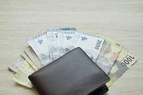 Small denominations of rupiah banknotes under the wallet. small change. cha.. Stock Photos