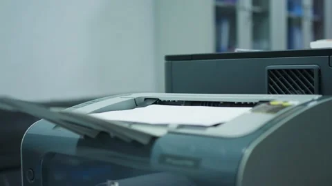 A small desktop printer is running Stock Footage 221459148