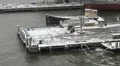 A small digger clears snow from a Manhattan Pier HD Footage