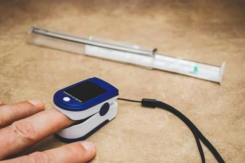 Small digital device for measuring pulse and blood oxygen level. Stock Photos