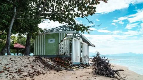 A small, dilapidated shack sits on a beach Stock Photos