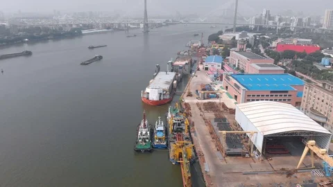 Small dock, tugs moored, large cargo ships. Stock Footage 118032943