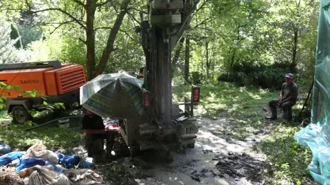 Small drilling rig   drilling water well for the country house. Stockbeeldmateriaal 219260722