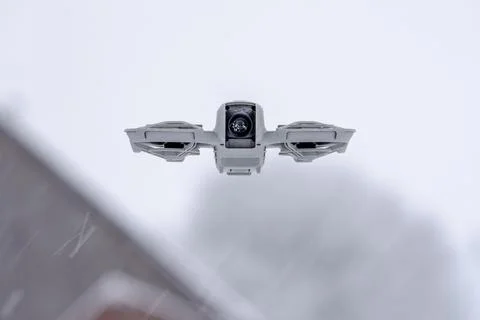 A small drone with a camera is flying in the snow Stock Photos