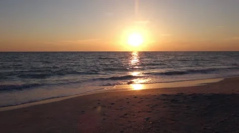 Small drone flying by at sunset on the beach Video stock 56948514