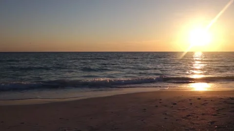 Small drone flying by at sunset on the beach Video stock 56948678