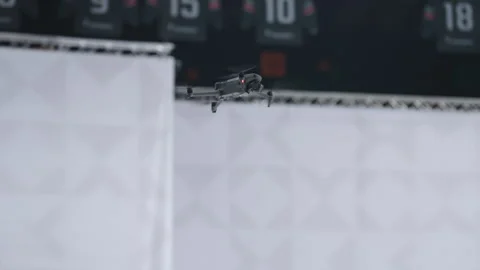 Small drone with propellers flies over hockey arena Stock Footage 324915130