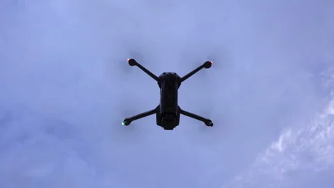 A small drone taking off into the blue sky Stock Footage 202140996