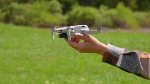 Small drone taking off from a hand outdoors 動画素材 340892884