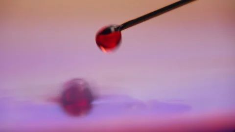Small drops of red blood falling from a metallic needle on surface full of blood Stock-Footage 127216225