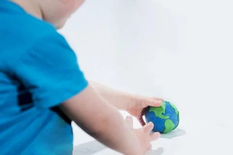 Small Earth model with human hands. Stock Photos