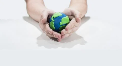 Small Earth model with human hands. Stock Photos