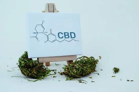 A small easel with the formula CBD and flowers buds of marijuana. Medical 스톡 사진