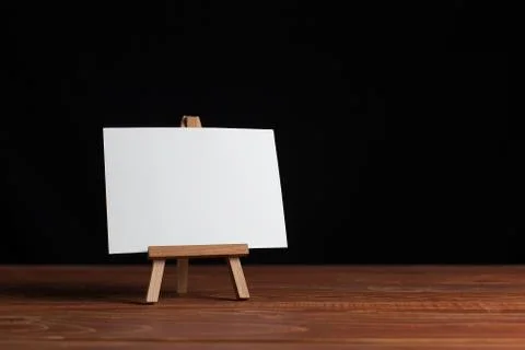 A small easel, a layout, a blank, white on a black background. Stock Photos