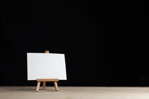 A small easel, a layout, a blank, white on a black background. Stock Photos