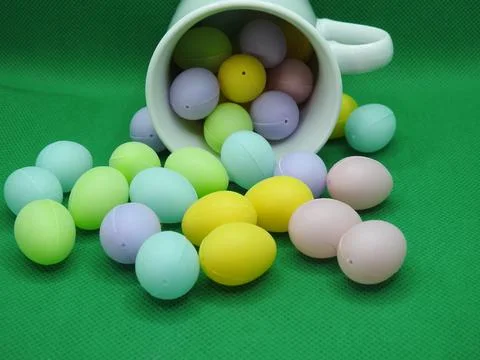 Small eggs spill from a cup Stock Photos
