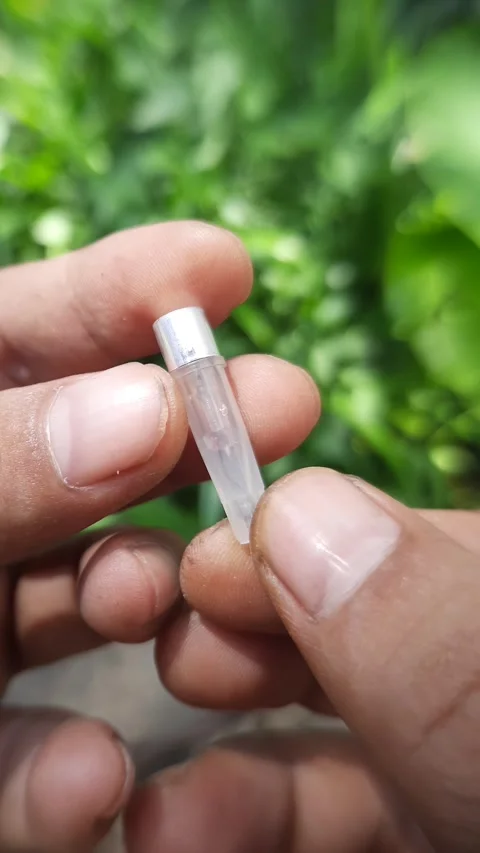 Small electrical neon bulb component, hands holding voltage tester part, ve.. Stock Footage 342628294
