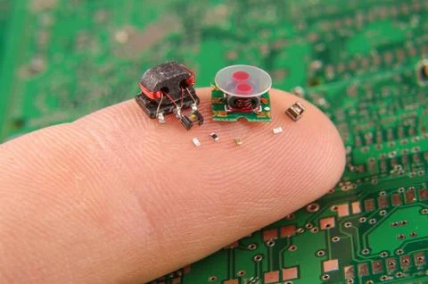 Small electronics components on human finger Stock Photos