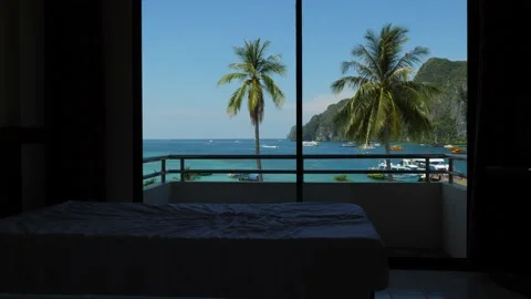 Small empty bed in dark room, sunny and green tropical bay seen outside Stock Footage 149826907