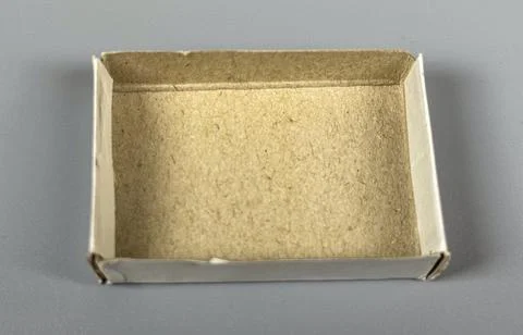 Small empty box for storage or organization on a plain surface Stock Photos