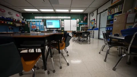 Small empty chairs and desks in an elementary school classroom with interactive 動画素材 248696447