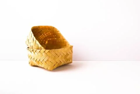 Small empty hand-woven bamboo wicker container placed inside lid facing up Stock Photos