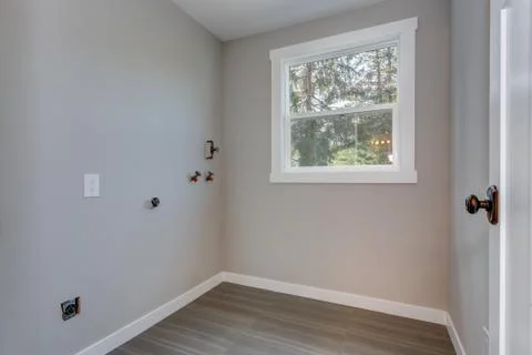 Small empty room with gray walls and tiled floor. Stock Photos