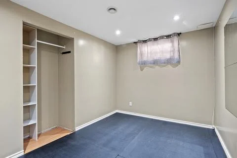 Small, empty room with a window and a closet Stock Photos