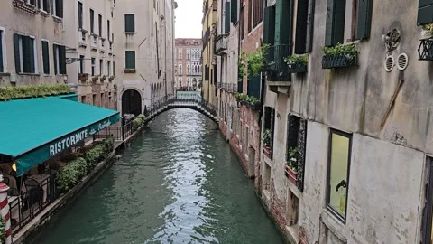 Small empty side canal and bridge-Venice-Restaurant Stock Footage 282228464