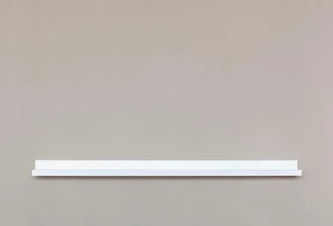 Small empty white shelf  on wall. Stock Photos