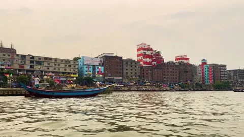 Small Engine boat with loaded cargo ship navigating on buriganga river with Stock Footage 334855275