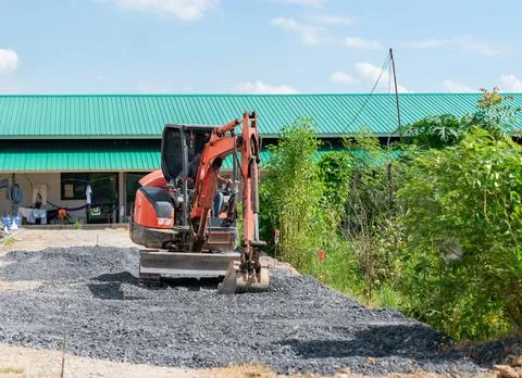 Small excavator adjust level road. Stock Photos