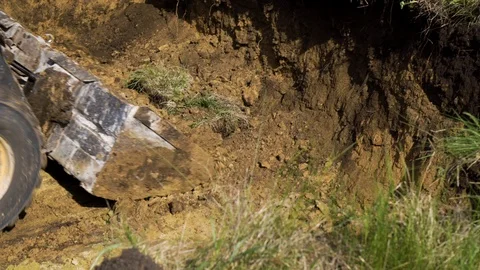 Small excavator digging foundation pit for new house Video stock 107653849