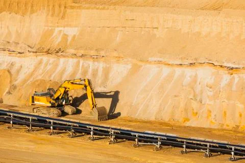 A small excavator at parked in a lignite pit mine Stock Photos