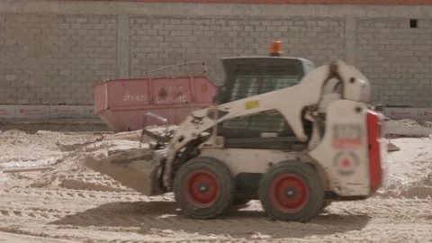 A small excavator rides on a construction site Stock Footage 132495067