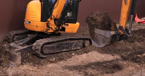 Small excavator working on a construction site. Construction works. Stock Footage 152506530