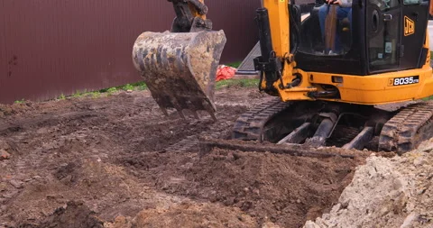 Small excavator working on a construction site. Construction works. Stock Footage 152507035