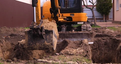 Small excavator working on a construction site. Construction works. Stock Footage 152507340