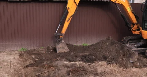 Small excavator working on a construction site. Construction works. Stock Footage 168188184