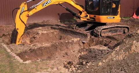 Small excavator working on a construction site. Construction works. Stock Footage 168190095