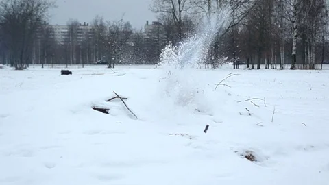 Small explosion inside snowpile, cracker cylinder and debris fly away, slowmo 스톡 동영상 84567676