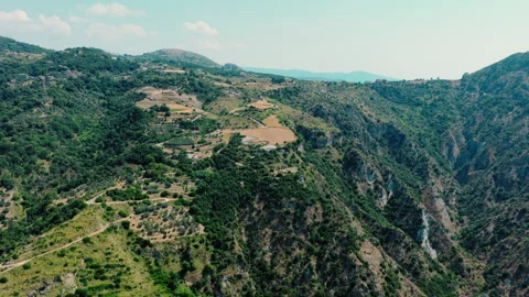 Small farm fields on a ridge above a deep rocky ravine Stock Footage 345088641