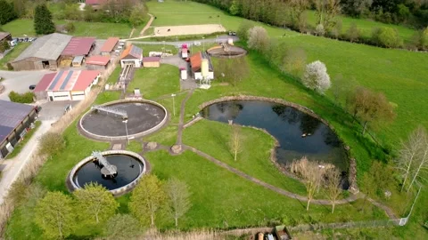 Small farm next to a pond, river and forest Stock Footage 154368903