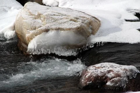 Small fast mountain river winter snow on the shore Stock Photos